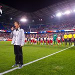 10-year-old Kyah Cahill sings the national anthem as his father looks on. (Rob Tringali/New York Red Bulls)